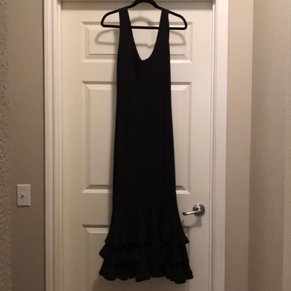 Black dress ruffled at bottom.
